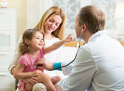 A doctor doing a home visit with a patient