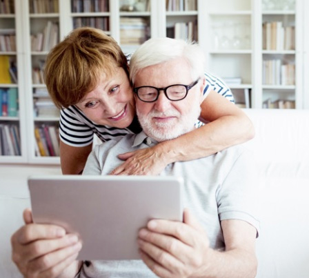 Image of two people looking at a tablet device